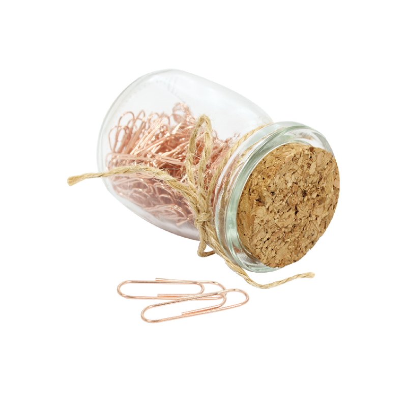 Paper clips in glass jar with cork lip
